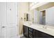 Bathroom features a double vanity with marble countertops and dark cabinets for a modern look at 7504 Frittata Ave, Las Vegas, NV 89113