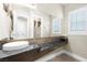 A stylish powder room features a unique vessel sink and granite countertop with decorative mirror at 7504 Frittata Ave, Las Vegas, NV 89113