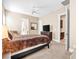 Bedroom with a ceiling fan, mounted TV, and carpet flooring at 7504 Frittata Ave, Las Vegas, NV 89113