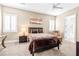 Cozy bedroom with a ceiling fan, shutters, and carpet flooring at 7504 Frittata Ave, Las Vegas, NV 89113