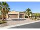 Front exterior of home with palm trees and a paved driveway at 7504 Frittata Ave, Las Vegas, NV 89113