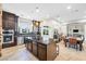 Lovely kitchen features granite counters, stainless appliances, island with seating, and bright dining area at 7504 Frittata Ave, Las Vegas, NV 89113