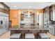 Open kitchen with a large island, stone accent over the range, and stainless appliances at 7504 Frittata Ave, Las Vegas, NV 89113
