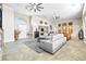 Spacious living area featuring tile floors, an open floor plan, and modern furnishings at 7504 Frittata Ave, Las Vegas, NV 89113