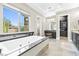 Bright primary bath features a large soaking tub, vanity area, and private commode at 7504 Frittata Ave, Las Vegas, NV 89113