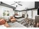 Primary bedroom with sitting area, slider to outdoor, plank flooring and neutral decor at 7504 Frittata Ave, Las Vegas, NV 89113