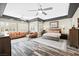 Spacious primary bedroom boasts tray ceilings, plank flooring, and a stylish seating arrangement at 7504 Frittata Ave, Las Vegas, NV 89113