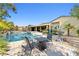 Beautiful outdoor pool area with desert landscaping, a hot tub, and comfortable seating at 7504 Frittata Ave, Las Vegas, NV 89113
