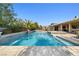 Sparkling pool with sun-drenched area, mature landscaping, and outdoor entertaining area at 7504 Frittata Ave, Las Vegas, NV 89113