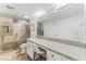Updated bathroom with a glass-enclosed shower, granite vanity, and large mirror at 753 Oakmont Ave # 802, Las Vegas, NV 89109