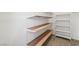 Walk-in closet with wooden shelving and carpeted floors providing an efficient storage solution at 753 Oakmont Ave # 802, Las Vegas, NV 89109