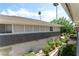 Exterior side view of a two-story house with manicured landscaping and a fenced-in patio at 753 Oakmont Ave # 802, Las Vegas, NV 89109