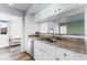 Bright kitchen with white cabinets, granite countertops, and stainless steel appliances, overlooking the living area at 753 Oakmont Ave # 802, Las Vegas, NV 89109