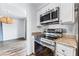 Kitchen detail showcasing stainless steel oven and microwave with granite countertops and white cabinetry at 753 Oakmont Ave # 802, Las Vegas, NV 89109