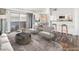 Bright living room with hardwood floors, a dining area, an open view to the kitchen, and a sliding glass door at 753 Oakmont Ave # 802, Las Vegas, NV 89109