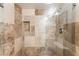 Shower featuring stone-look tiling, a built-in shower bench, and a recessed shelf for shower products at 753 Oakmont Ave # 802, Las Vegas, NV 89109