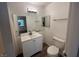 Cozy bathroom featuring a modern vanity, mirror, and wood-look flooring at 8017 Cherish Ave, Las Vegas, NV 89128