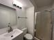 Bright bathroom featuring a modern vanity, shower, and wood-look flooring at 8017 Cherish Ave, Las Vegas, NV 89128