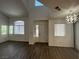 Open concept living room with wood-look floors, bright windows, and modern lighting at 8017 Cherish Ave, Las Vegas, NV 89128