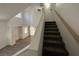 Carpeted stairs ascend past white walls with a wood handrail at 8017 Cherish Ave, Las Vegas, NV 89128
