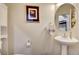 Well-lit powder room with pedestal sink and stylish accessories creating a simple and functional space at 831 E Galingale Ct, Henderson, NV 89015
