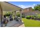 Inviting covered patio with comfortable seating, complemented by a well-maintained lawn and garden at 831 E Galingale Ct, Henderson, NV 89015