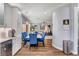 Open dining area with hardwood floors that connects to living area, adjacent to the kitchen with modern appliances at 831 E Galingale Ct, Henderson, NV 89015