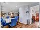 Stylish dining area adjacent to the living room, featuring modern blue chairs and a white marble table at 831 E Galingale Ct, Henderson, NV 89015