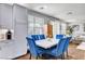 Bright dining area featuring white cabinets, stainless appliances and stylish blue seating at 831 E Galingale Ct, Henderson, NV 89015