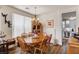 Bright dining room features a wood table, chandelier, and decorative accents, creating a welcoming atmosphere at 831 E Galingale Ct, Henderson, NV 89015