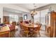 Cozy dining room with wood floors, chandelier, and seating for six, perfect for Gathering meals and gatherings at 831 E Galingale Ct, Henderson, NV 89015