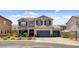 Charming two-story home with a well-maintained lawn, mature plants, and a two-car garage at 831 E Galingale Ct, Henderson, NV 89015