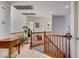 Bright upstairs hallway with wood railing, neutral carpet, and access to multiple rooms at 831 E Galingale Ct, Henderson, NV 89015
