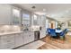 Modern kitchen with white cabinets, stainless steel appliances, and connection to dining area at 831 E Galingale Ct, Henderson, NV 89015