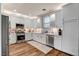 Bright kitchen with white cabinets, stainless steel appliances, quartz counters, and stylish tile backsplash at 831 E Galingale Ct, Henderson, NV 89015