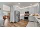 Modern kitchen featuring stainless steel appliances, white cabinets and a view to the dining area at 831 E Galingale Ct, Henderson, NV 89015