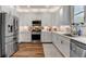 Bright kitchen featuring stainless appliances, white cabinets and counter tops with tile back splash at 831 E Galingale Ct, Henderson, NV 89015