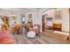 Spacious living room featuring laminate floors, vintage furniture, and charming decor at 831 E Galingale Ct, Henderson, NV 89015