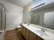 Bathroom vanity featuring double sinks, ample cabinet space, and neutral countertops at 855 N Stephanie St # 2311, Henderson, NV 89014