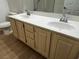 Bathroom vanity featuring double sinks, ample cabinet space, and neutral countertops at 855 N Stephanie St # 2311, Henderson, NV 89014