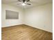Well-lit bedroom showcases neutral walls, ceiling fan, wood flooring, and a window for a serene retreat at 855 N Stephanie St # 2311, Henderson, NV 89014