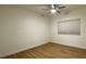 Well-lit bedroom showcases neutral walls, ceiling fan, wood flooring, and a window for a serene retreat at 855 N Stephanie St # 2311, Henderson, NV 89014