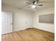 Well-lit bedroom showcases neutral walls, ceiling fan, wood flooring, and a window for a serene retreat at 855 N Stephanie St # 2311, Henderson, NV 89014