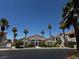 A view of the community clubhouse surrounded by beautiful palms and well-maintained landscaping at 855 N Stephanie St # 2311, Henderson, NV 89014