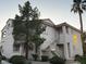 Building exterior with stairs and mature trees creating a picturesque view at 855 N Stephanie St # 2311, Henderson, NV 89014