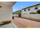 Enclosed backyard featuring a red brick patio, bench seating, and stucco walls at 8789 Villa Alex Ave, Las Vegas, NV 89147