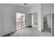 Bright bedroom with hardwood floors, mirrored closet, and a balcony, enhanced by natural light and an open layout at 8789 Villa Alex Ave, Las Vegas, NV 89147