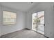 Bright bedroom featuring a sliding door with a balcony and gray wood-look flooring at 8789 Villa Alex Ave, Las Vegas, NV 89147