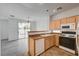 Eat-in kitchen with granite countertops, tile floors, light wood cabinets, and modern appliances at 8789 Villa Alex Ave, Las Vegas, NV 89147