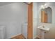 Convenient laundry room includes a utility sink, washer, and dryer hookups with storage at 8789 Villa Alex Ave, Las Vegas, NV 89147